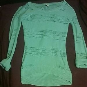 A long sleeved teal sweater.